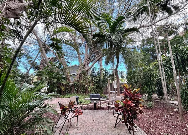 a view of swimming pool with outdoor seating and plants