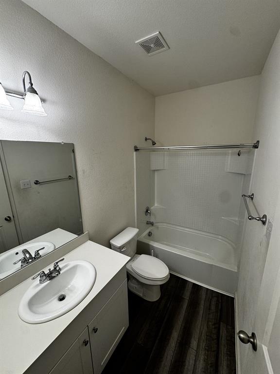1813 Chapel Hill Road Princeton, TX 75407 - Photo 16 of 20 White vanity with integrated sink, chrome faucet, and dark wood-finish flooring