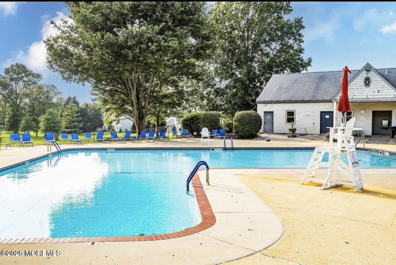 a view of a swimming pool with lounge chairs