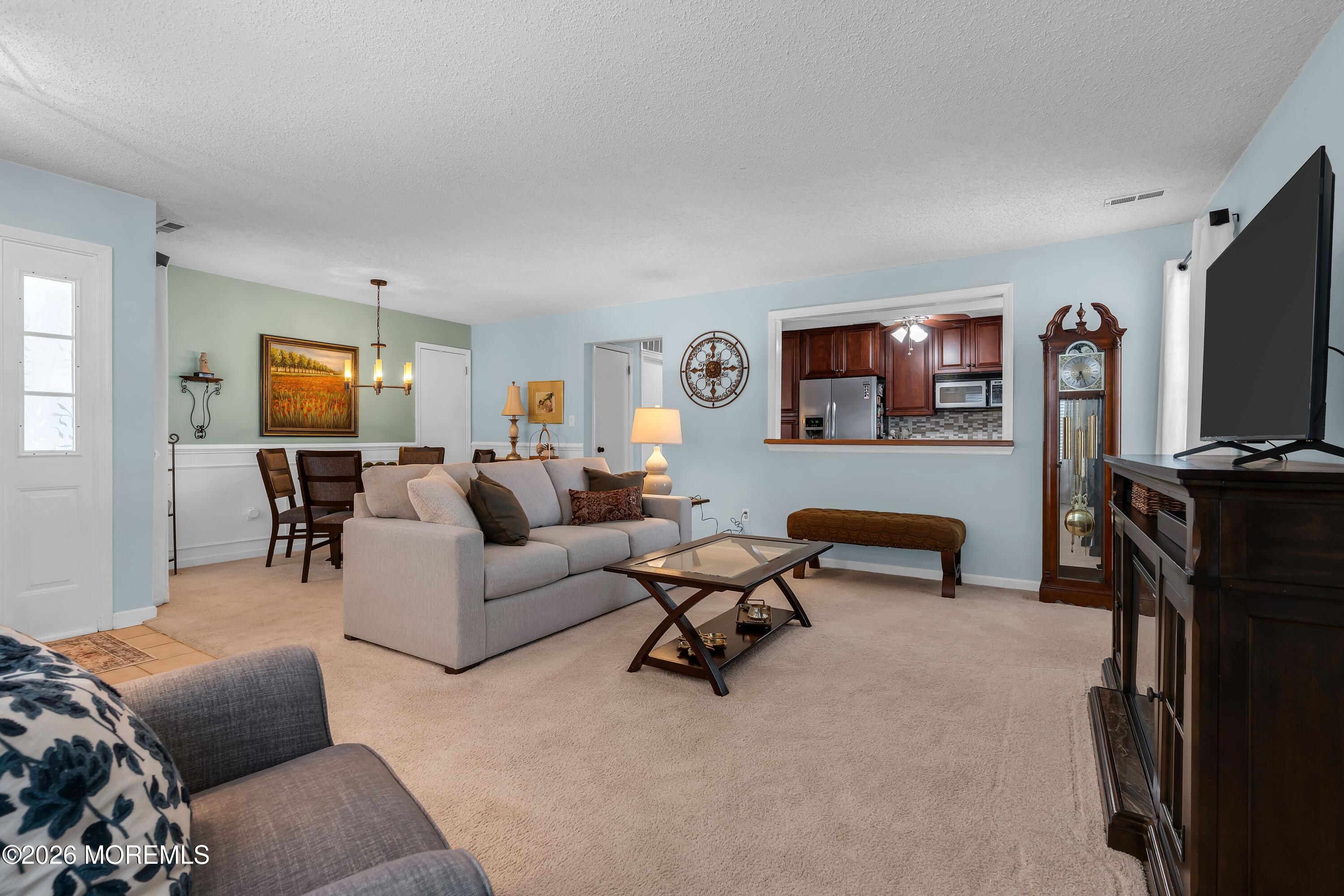 129 Tulip Lane Freehold, NJ 07728 - Photo 4 of 25 a living room with furniture and a flat screen tv