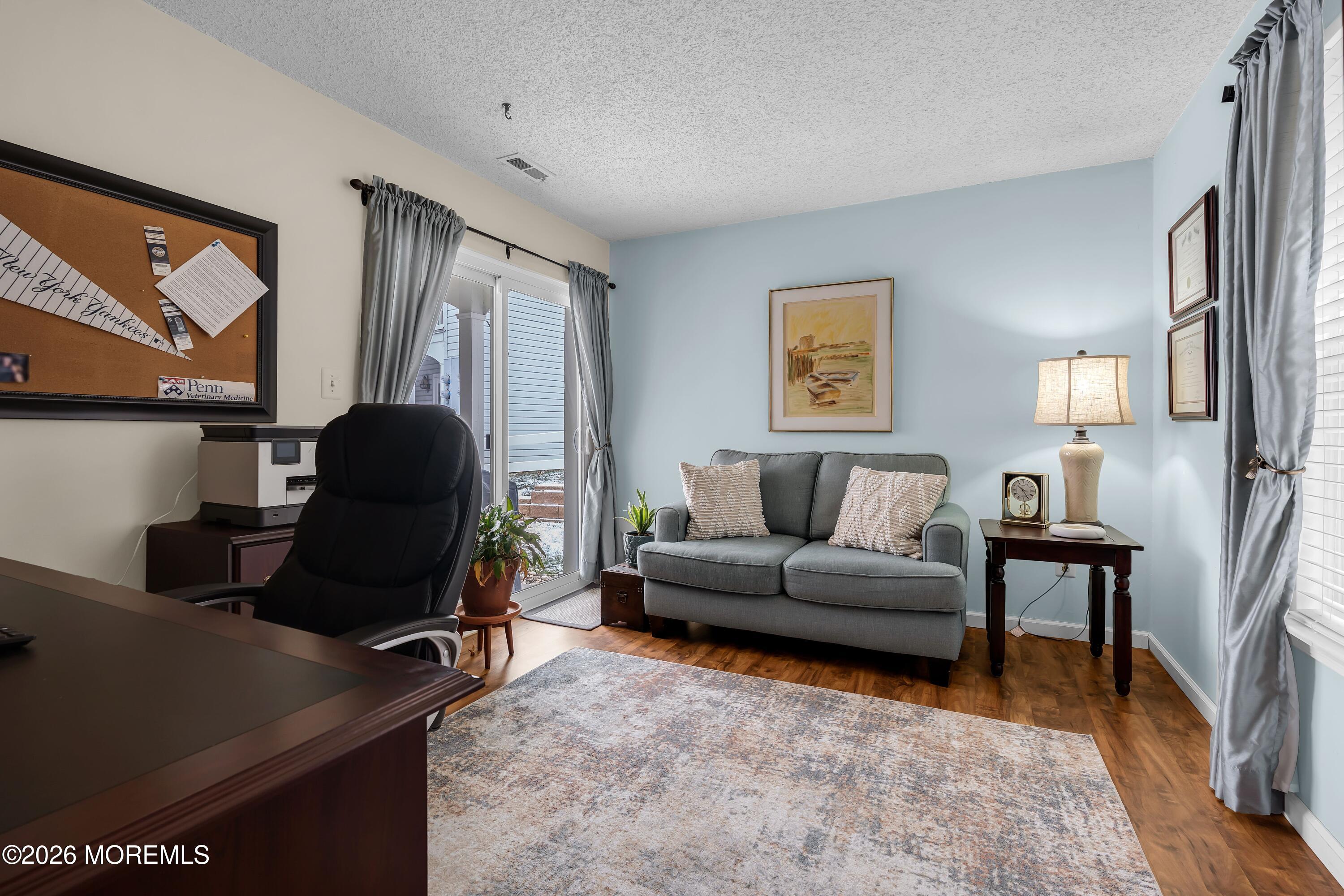 129 Tulip Lane Freehold, NJ 07728 - Photo 8 of 25 a living room with furniture and a flat screen tv