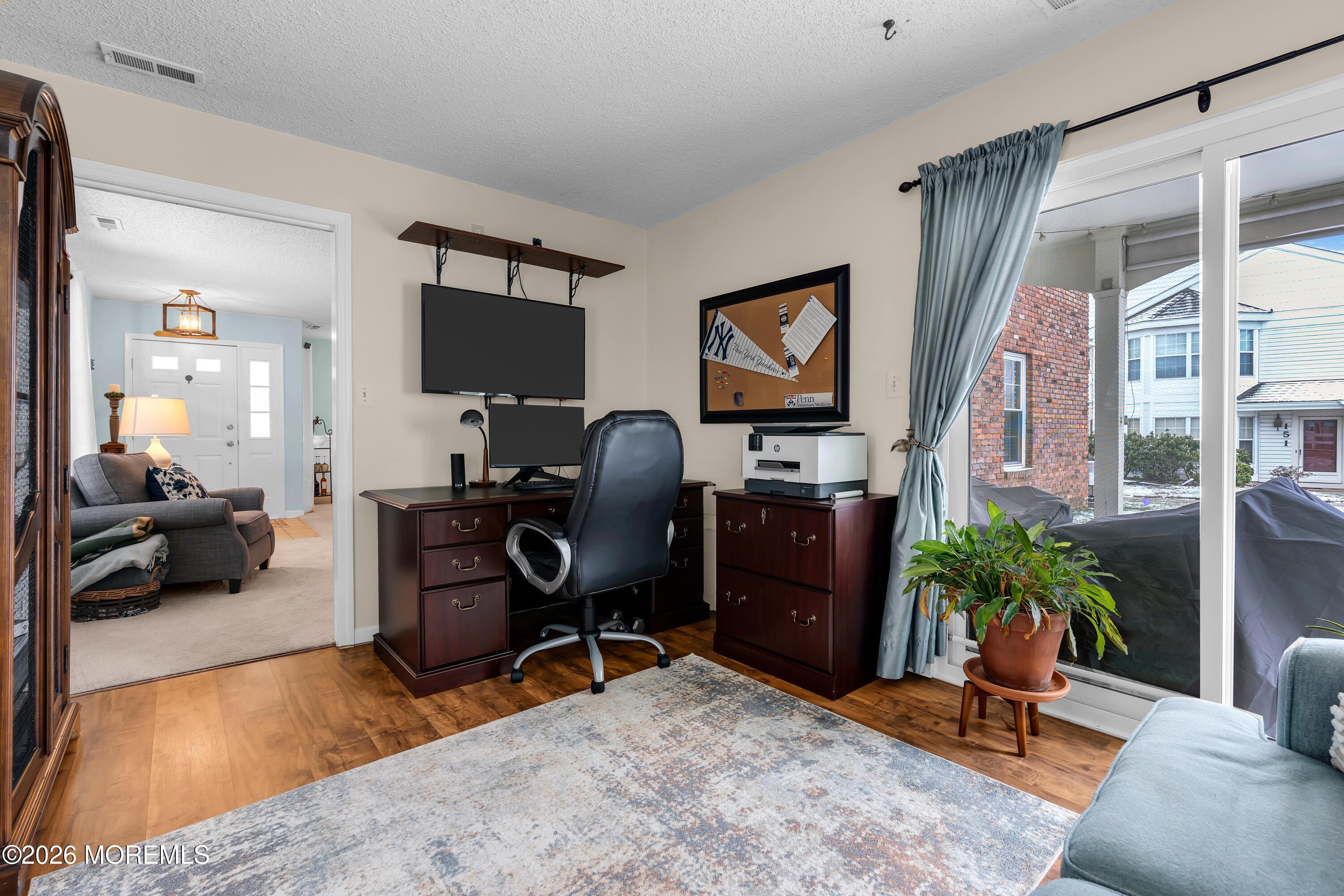 129 Tulip Lane Freehold, NJ 07728 - Photo 9 of 25 a living room with furniture workspace and a flat screen tv