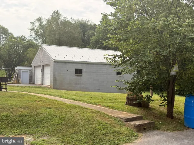 a view of a house with a yard and garage