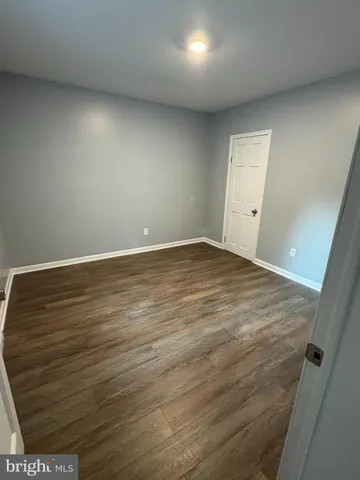 an empty room with wooden floor