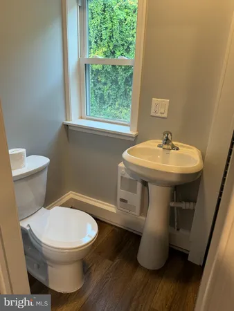 a bathroom with a toilet sink and mirror