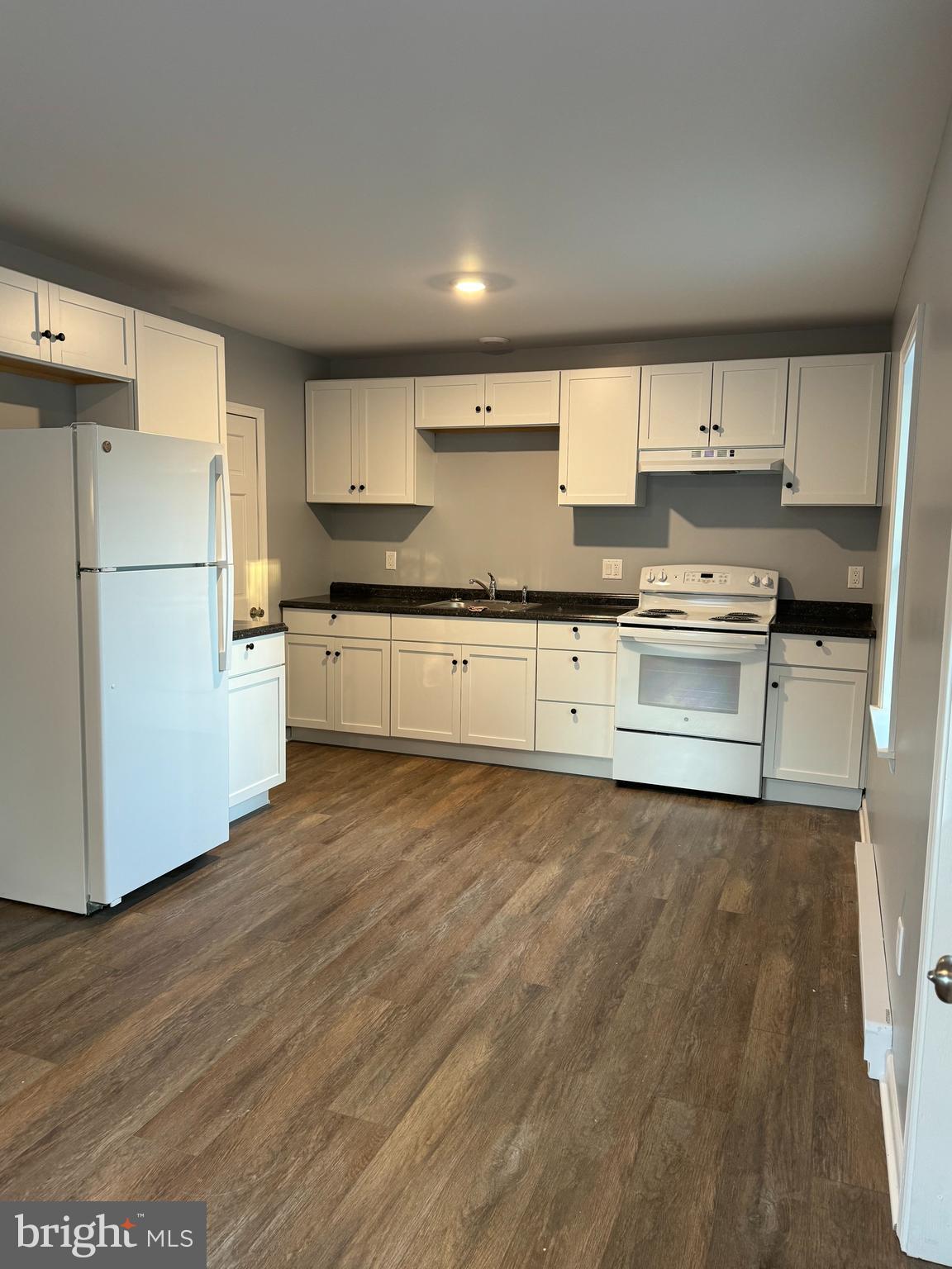 9947 Crossfield Road Hagerstown, MD 21740 - Photo 18 of 39 a kitchen with stainless steel appliances granite countertop a stove top oven a refrigerator a sink and dishwasher with wooden floor