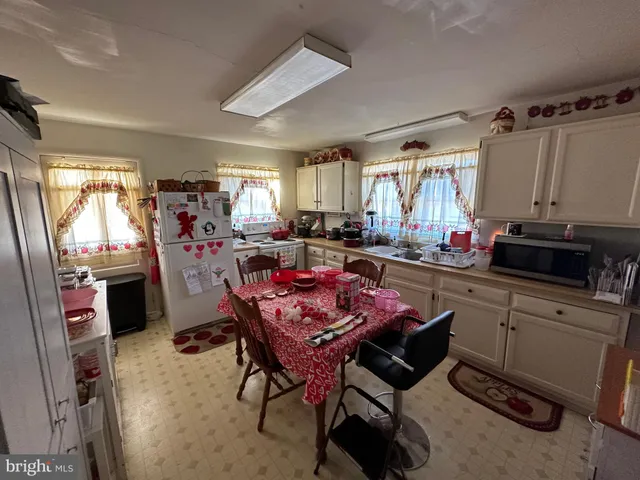 a bedroom with two beds and a dresser