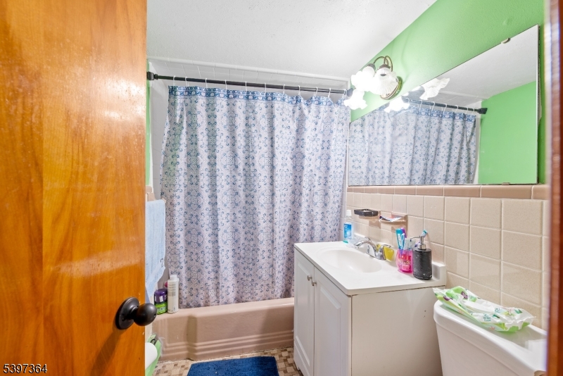 21 Laurie Road Landing, NJ 07850 - Photo 11 of 14 a bathroom with a sink a bath tub and a shower curtain