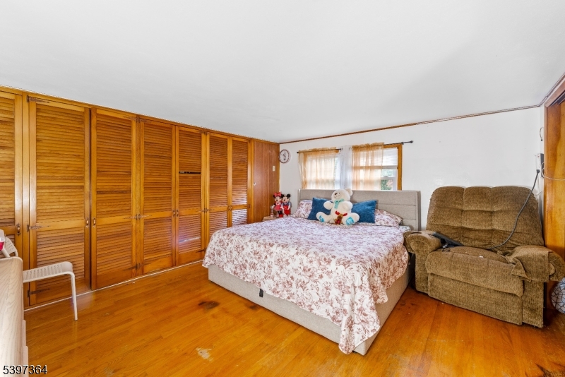 21 Laurie Road Landing, NJ 07850 - Photo 7 of 14 a bed room with a bed and wooden floor