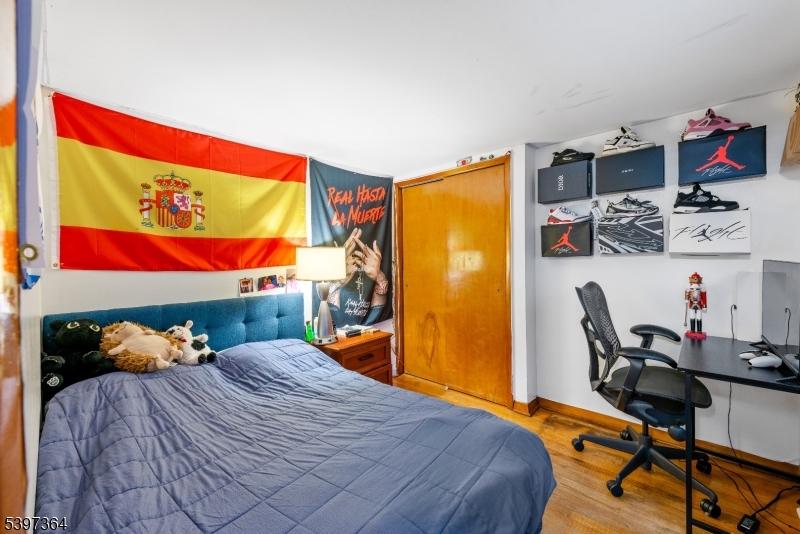 21 Laurie Road Landing, NJ 07850 - Photo 9 of 14 a bedroom with a bed and dresser with wooden floor
