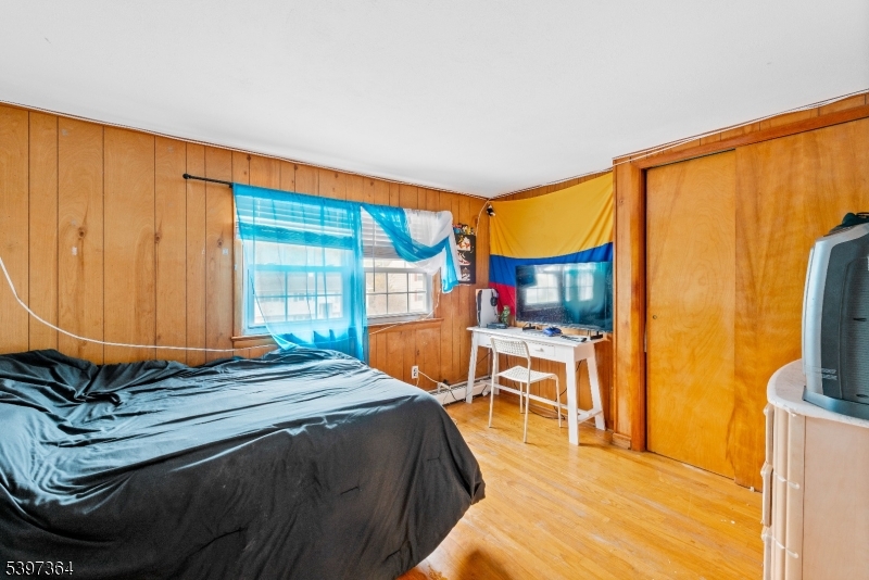 21 Laurie Road Landing, NJ 07850 - Photo 10 of 14 a bedroom with a bed and wooden floor
