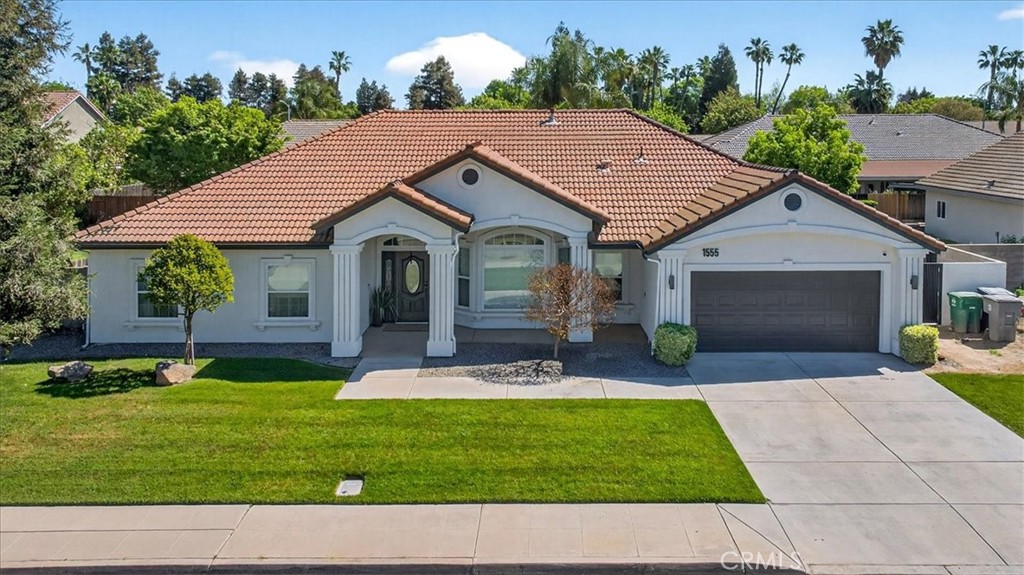 1555 Taylor Street Madera, CA 93637 - Photo 1 of 75 a aerial view of a house with a yard patio and swimming pool