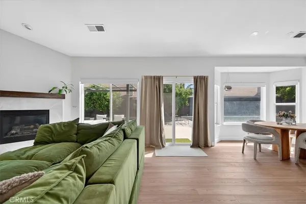 a living room with furniture a table and a potted plant