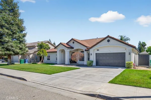 a front view of house with yard and green space
