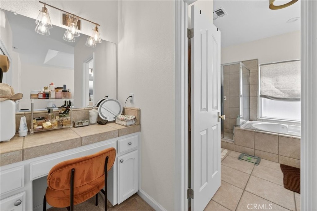 1555 Taylor Street Madera, CA 93637 - Photo 55 of 75 a bathroom with a sink a vanity and a mirror