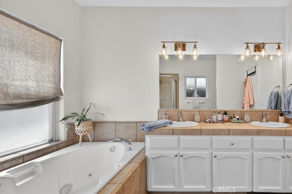 1555 Taylor Street Madera, CA 93637 - Photo 57 of 75 a bathroom with a sink and a mirror