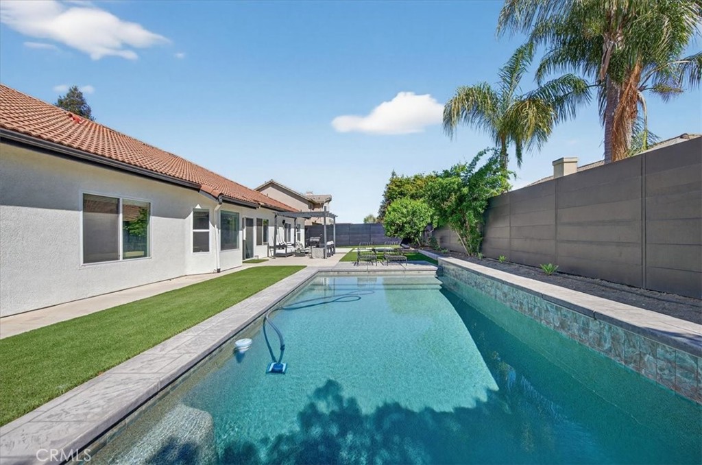 1555 Taylor Street Madera, CA 93637 - Photo 65 of 75 a view of a house with a swimming pool