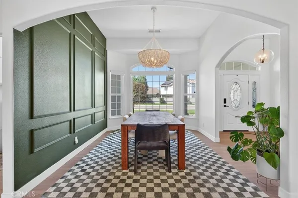 a kitchen with stainless steel appliances a refrigerator cabinets and wooden floor