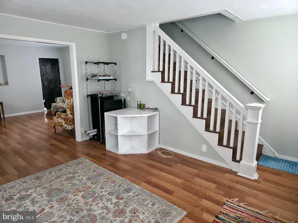 a view of entryway livingroom and hall with wooden floor