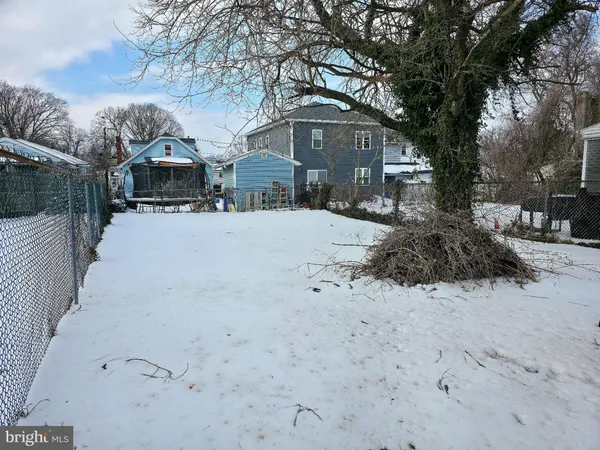 a front view of a house with a yard covered in snow