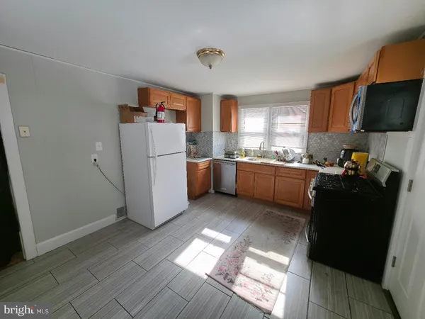 a kitchen with a refrigerator and a sink