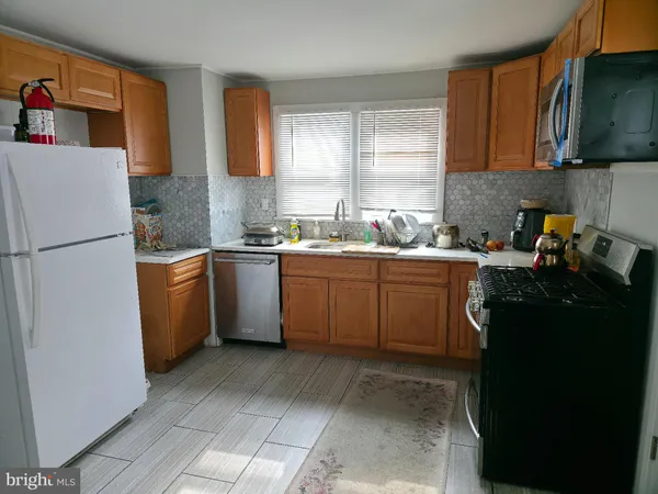 a kitchen with a sink a stove and refrigerator