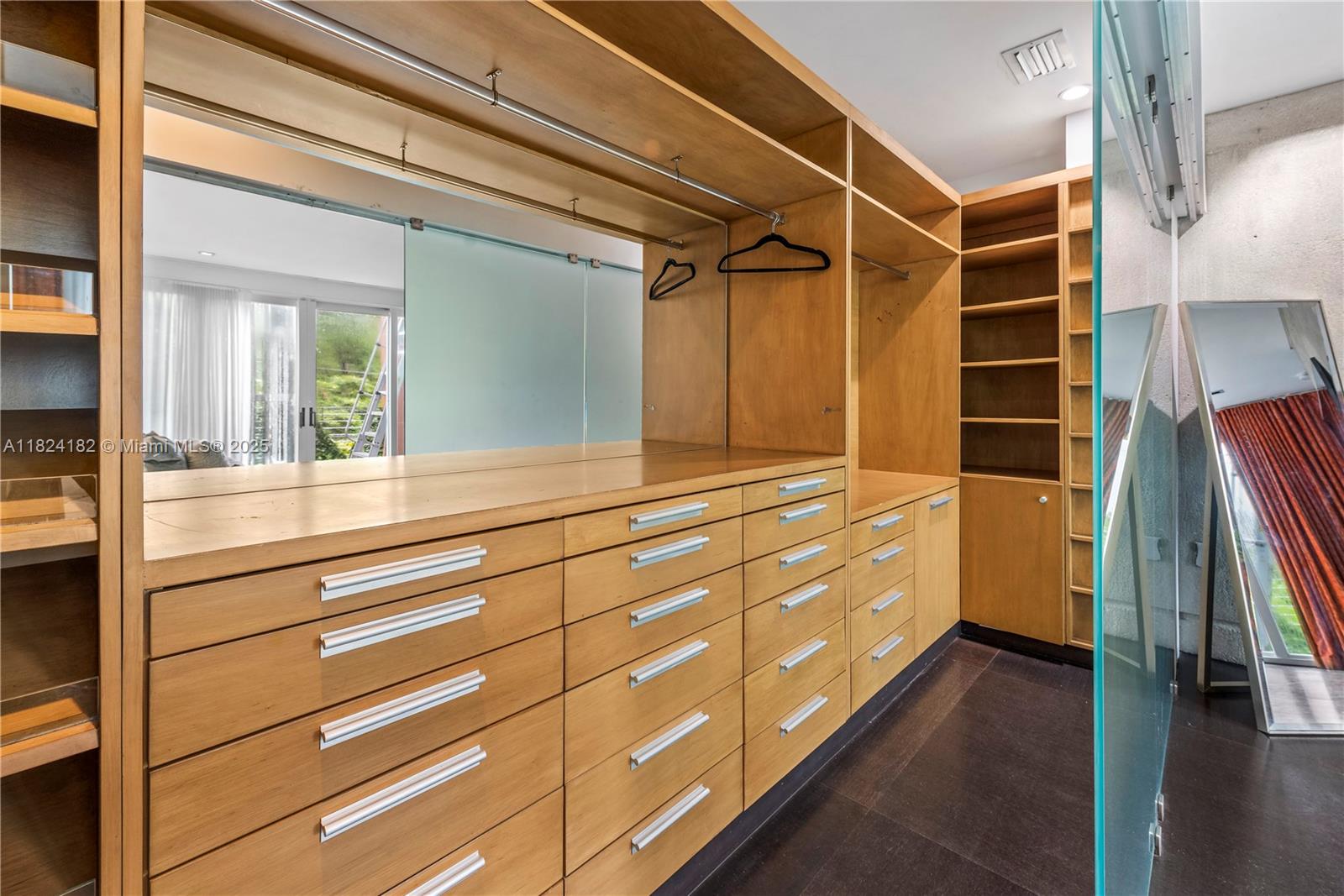 1606 South Bayshore Drive Miami, FL 33133 - Photo 19 of 54 a view of walk in closet with clothes and shoes