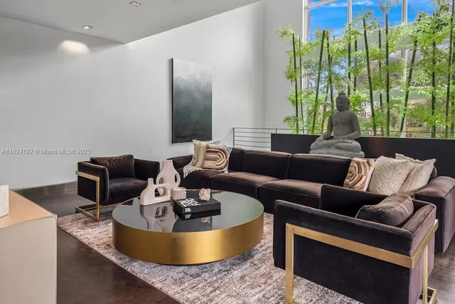 a living room with furniture a large window and a table