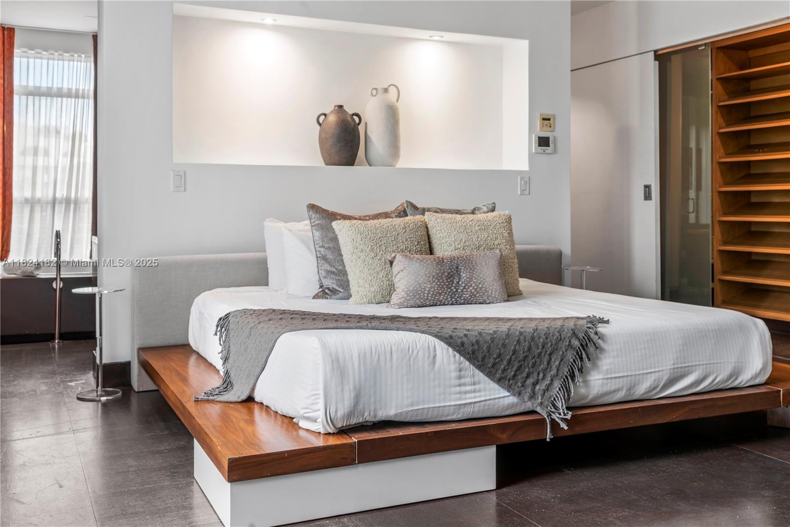 1606 South Bayshore Drive Miami, FL 33133 - Photo 22 of 54 a bedroom with a bed and wooden floor