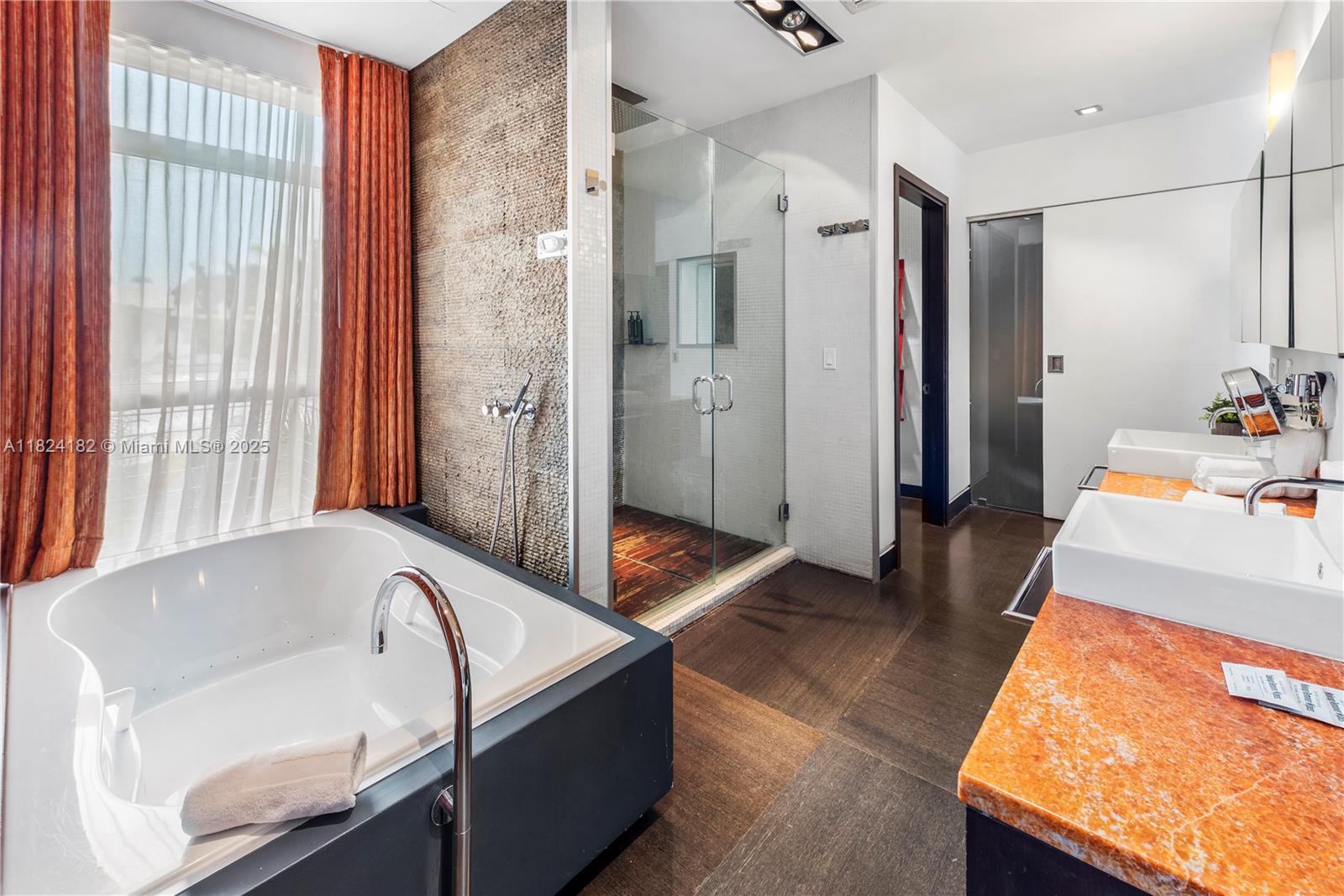 1606 South Bayshore Drive Miami, FL 33133 - Photo 27 of 54 a bathroom with a tub sink and mirror