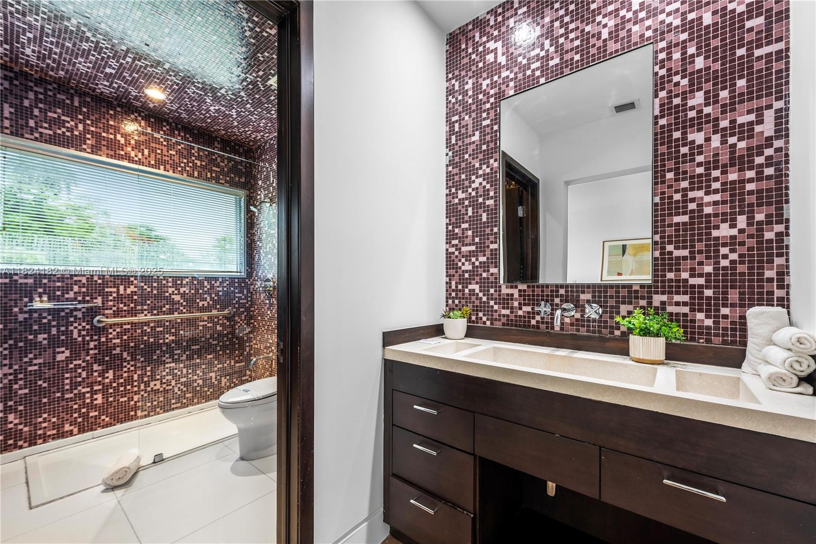 1606 South Bayshore Drive Miami, FL 33133 - Photo 35 of 54 a bathroom with a sink and a mirror