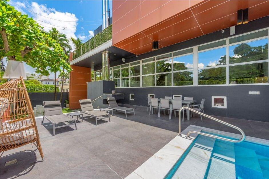 1606 South Bayshore Drive Miami, FL 33133 - Photo 49 of 54 a view of a patio with a dining table and chairs with wooden floor