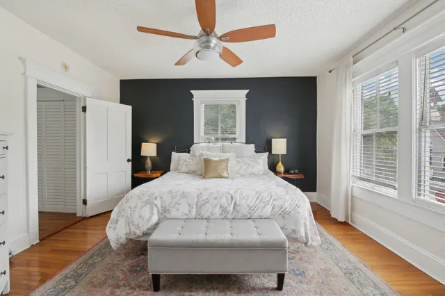 a bedroom with a large bed and a chandelier