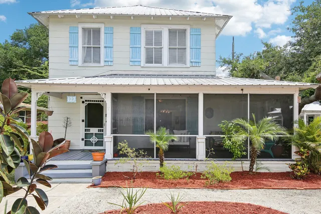 an aerial view of a house with a yard and lake view