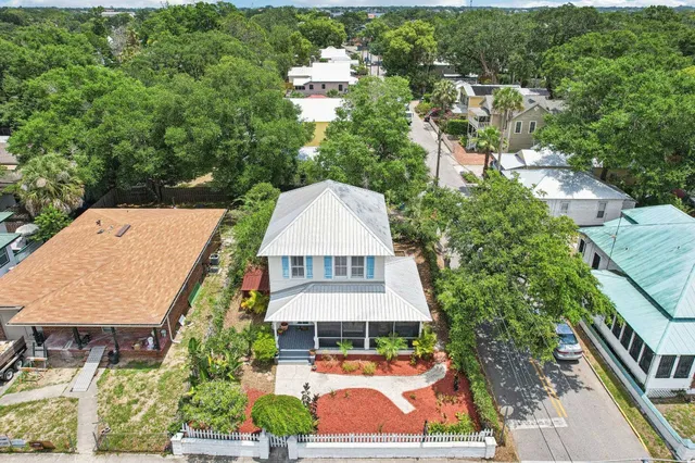 an aerial view of residential houses with outdoor space and swimming pool