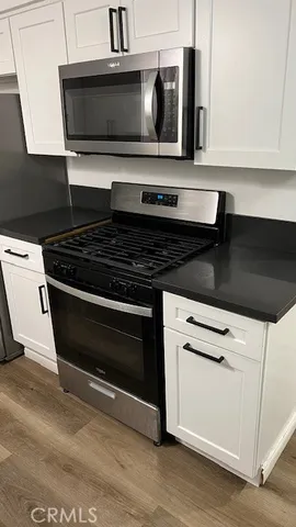 a kitchen with wooden cabinets and oven