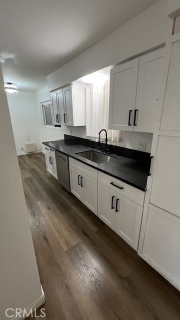 12950 5th Street, Unit 10 Chino, CA 91710 - Photo 6 of 11 a kitchen with granite countertop white cabinets and sink