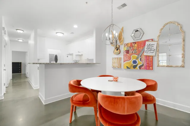 a dining room with furniture and chandelier