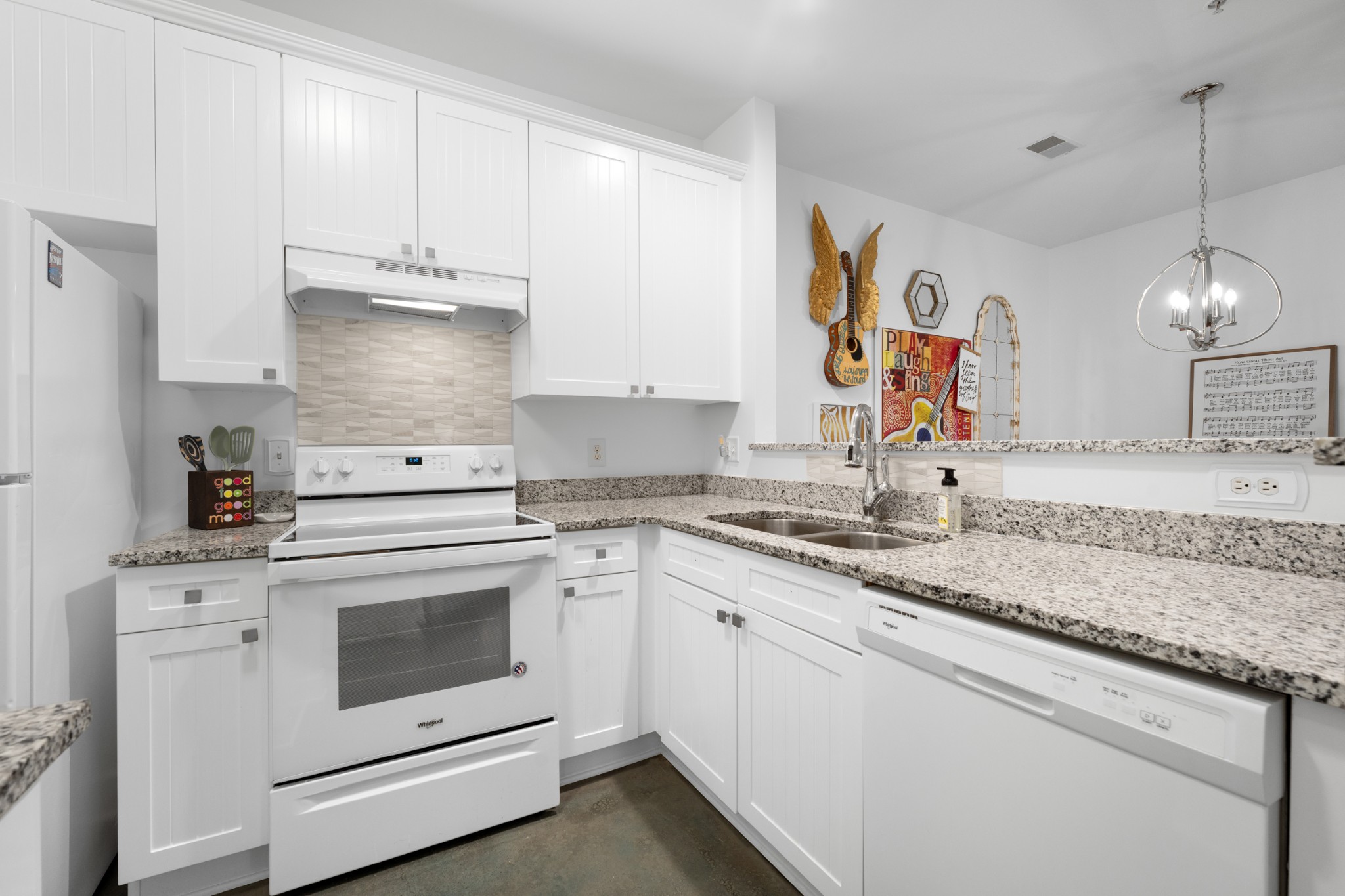 7219 Althorp Way, Unit L4 Nashville, TN 37211 - Photo 14 of 36 a kitchen with granite countertop white cabinets and white appliances
