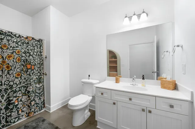 a bathroom with a sink toilet and shower