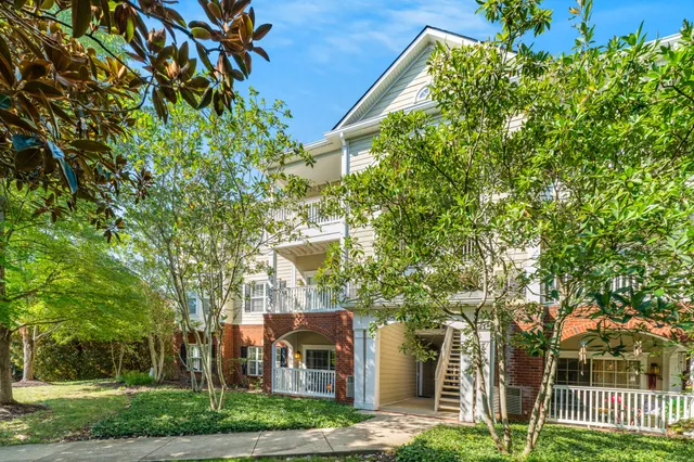 an aerial view of a house with a yard and lake view