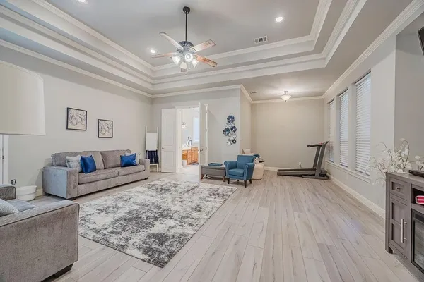 a living room with furniture and a chandelier
