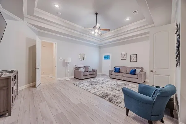 a living room with furniture and a chandelier