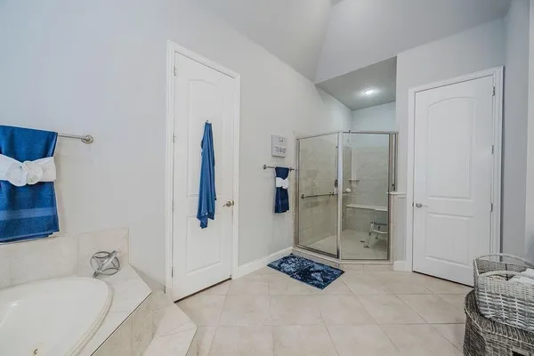 a bathroom with a tub shower and sink