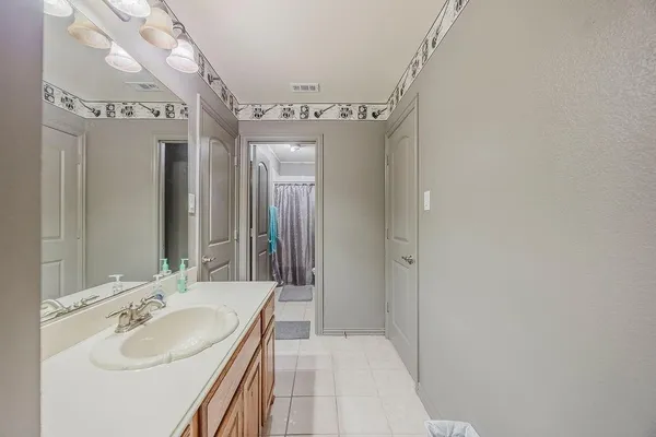 a spacious bathroom with a double vanity sink and a mirror
