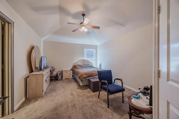 a living room with furniture a flat screen tv and a window