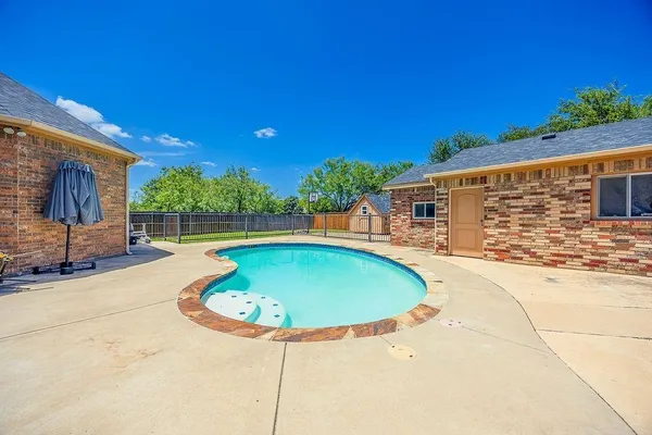 a view of a swimming pool with a patio
