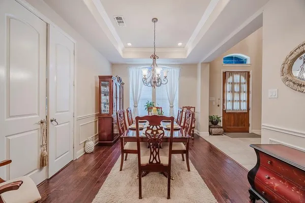 a view of a a dining room with furniture window and wooden floor