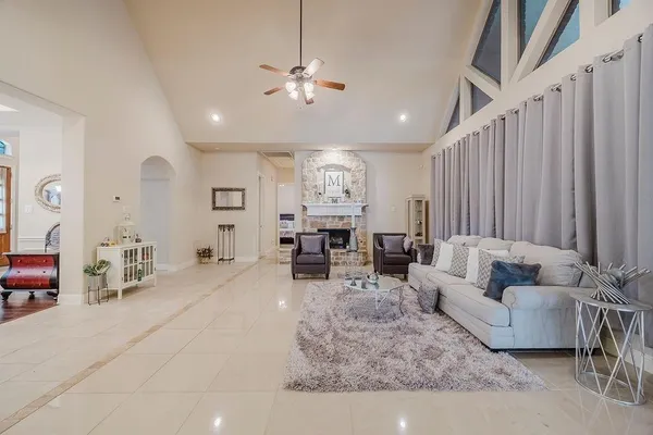 a living room with furniture and a chandelier