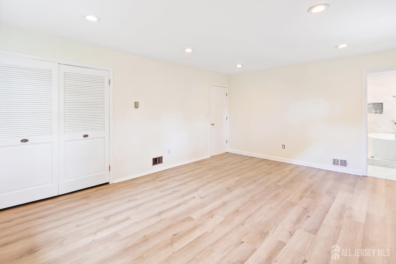 10 Woodruff Road Edison, NJ 08820 - Photo 10 of 18 an empty room with wooden floor